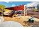 Community playground with colorful equipment, shade structure, and seating area at 165 Calm Morning Ave, Henderson, NV 89002