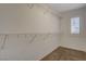 Walk-in closet features carpet, wire shelving, and a shuttered window for natural light at 165 Calm Morning Ave, Henderson, NV 89002