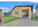 Backyard featuring artificial turf, a patio, and a covered dining area at 2104 Leatherbridge Ct, North Las Vegas, NV 89081