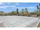 A community basketball court has picnic tables, benches, and mature shade trees for residents at 2104 Leatherbridge Ct, North Las Vegas, NV 89081