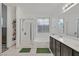 Bright bathroom with a double vanity, soaking tub, and separate shower at 2104 Leatherbridge Ct, North Las Vegas, NV 89081