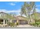 Charming single-story home with a two-car garage and a well-manicured front yard at 2104 Leatherbridge Ct, North Las Vegas, NV 89081