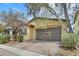 A single-story home offers a two-car garage, neutral paint, and drought-resistant landscaping at 2104 Leatherbridge Ct, North Las Vegas, NV 89081