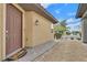 A quaint front door sits near desert landscaping with a stone walkway on a sunny day at 2104 Leatherbridge Ct, North Las Vegas, NV 89081