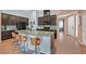 Kitchen showcases a large island with seating, a microwave, and opens to the living spaces at 2104 Leatherbridge Ct, North Las Vegas, NV 89081