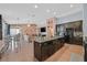 Open concept kitchen features a center island, stainless steel appliances, and seamlessly connects to the dining and living areas at 2104 Leatherbridge Ct, North Las Vegas, NV 89081