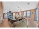 Spacious living area with a comfortable sofa, stylish decor, and seamless flow to the adjacent dining and kitchen spaces at 2104 Leatherbridge Ct, North Las Vegas, NV 89081