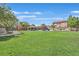 A neighborhood playground has swings, slides, and picnic tables surrounded by a vast lawn at 2104 Leatherbridge Ct, North Las Vegas, NV 89081