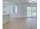 Open floor plan with kitchen bar, wood floors, and a sliding glass door at 212 View Dr, Las Vegas, NV 89107