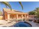 Beautiful backyard featuring a pool, spa, covered patio, and lush landscaping offering a private outdoor oasis at 2143 Vista Famosa Ct, Las Vegas, NV 89123