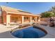 This backyard features a pool, an overhang, a built-in grill, and a privacy wall at 2143 Vista Famosa Ct, Las Vegas, NV 89123
