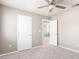 Bedroom with neutral walls, carpet flooring, and two white doors with silver hardware at 2143 Vista Famosa Ct, Las Vegas, NV 89123