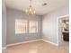 Dining room featuring hardwood floors, an elegant chandelier, and a view of the kitchen at 2143 Vista Famosa Ct, Las Vegas, NV 89123