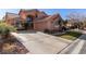 Attractive two-story home with desert landscaping, an attached garage, and an extended driveway at 2143 Vista Famosa Ct, Las Vegas, NV 89123