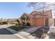 Inviting home with a well-maintained lawn, desert landscaping, and a two-car garage at 2143 Vista Famosa Ct, Las Vegas, NV 89123