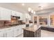 Modern kitchen boasts white cabinets, granite countertops, stainless appliances, and large island at 2143 Vista Famosa Ct, Las Vegas, NV 89123