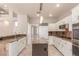 Spacious kitchen boasts white cabinets, granite counters, stainless appliances, and center island at 2143 Vista Famosa Ct, Las Vegas, NV 89123