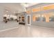 Bright living room with attached kitchen, tile floors, large windows, and backyard access at 2143 Vista Famosa Ct, Las Vegas, NV 89123