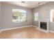 Cozy living room featuring hardwood floors, lots of natural light, and a fireplace at 2143 Vista Famosa Ct, Las Vegas, NV 89123