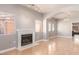 Bright living room featuring hardwood floors, fireplace, and arched doorways at 2143 Vista Famosa Ct, Las Vegas, NV 89123