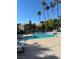 Community pool with clear blue water and plenty of lounging space in sunny environment at 221 Mission Newport Ln # 205, Las Vegas, NV 89107