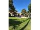 Community features mature landscaping and multi-story buildings with a lawn area, offering serene ambiance at 221 Mission Newport Ln # 205, Las Vegas, NV 89107