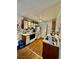 Efficient kitchen layout with white appliances, wood cabinets, and durable laminate flooring at 221 Mission Newport Ln # 205, Las Vegas, NV 89107