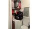 Stacked laundry appliances with a shelf that holds personal items and laundry products at 221 Mission Newport Ln # 205, Las Vegas, NV 89107