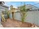 Backyard landscaping with trees and grey brick perimeter wall, ideal for outdoor relaxation and gardening at 2377 Los Feliz St, Las Vegas, NV 89156