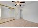 This bedroom features tile flooring and mirrored closet doors at 2377 Los Feliz St, Las Vegas, NV 89156