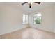 Bedroom with tile flooring, a ceiling fan, and a large arched window at 2377 Los Feliz St, Las Vegas, NV 89156