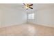 Bright bedroom with ceiling fan and tile flooring provides neutral backdrop at 2377 Los Feliz St, Las Vegas, NV 89156