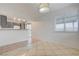 Well-lit dining area with tile flooring open to the kitchen and a sliding door to the patio at 2377 Los Feliz St, Las Vegas, NV 89156