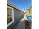 Exterior view showcasing stucco siding, windows, and a narrow walkway at 2377 Los Feliz St, Las Vegas, NV 89156