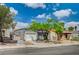 Charming single-story home featuring mature landscaping, a well-maintained lawn, and a two-car garage at 2377 Los Feliz St, Las Vegas, NV 89156