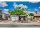 Charming single-story home featuring mature landscaping, a well-maintained lawn, and a two-car garage at 2377 Los Feliz St, Las Vegas, NV 89156