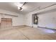 Well-lit garage featuring concrete floors and a wall-mounted water heater at 2377 Los Feliz St, Las Vegas, NV 89156