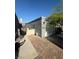 Single car garage with a brick driveway and gated access to the backyard at 2377 Los Feliz St, Las Vegas, NV 89156