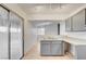 Modern kitchen with stainless steel sink, gray cabinets, and a sliding door to the patio at 2377 Los Feliz St, Las Vegas, NV 89156