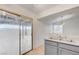 Bright kitchen features a double stainless steel sink and sliding glass door leading to backyard at 2377 Los Feliz St, Las Vegas, NV 89156