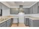 Modern kitchen with stylish gray cabinets, stainless steel sink, and contemporary lighting at 2377 Los Feliz St, Las Vegas, NV 89156