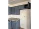 Kitchen featuring blue cabinets, gray countertops, and white walls at 2377 Los Feliz St, Las Vegas, NV 89156