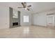 Open living room with tile flooring, ceiling fan, and decorative brick fireplace at 2377 Los Feliz St, Las Vegas, NV 89156