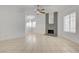 Spacious living room with tile flooring, a ceiling fan, and a brick fireplace with a mirror at 2377 Los Feliz St, Las Vegas, NV 89156