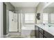 Modern bathroom showcasing a glass-enclosed shower, soaking tub, and vanity with ample countertop space at 250 Aspen Bay Ln, Henderson, NV 89012