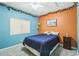 Charming bedroom with light blue and orange walls, ceiling fan, and window with natural light at 250 Aspen Bay Ln, Henderson, NV 89012