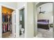 Bright bedroom boasts neutral walls, carpet, ceiling fan, and adjoining closet and half bathroom at 250 Aspen Bay Ln, Henderson, NV 89012