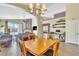 Open-concept dining area adjacent to living room with fireplace, showcasing a seamless living space at 250 Aspen Bay Ln, Henderson, NV 89012