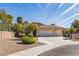 Inviting single-story house showcasing a three-car garage, desert landscaping, and a well-maintained front yard at 250 Aspen Bay Ln, Henderson, NV 89012