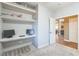 Cozy home office with gray walls, built-in shelving, floating desk, and carpeted floors at 250 Aspen Bay Ln, Henderson, NV 89012